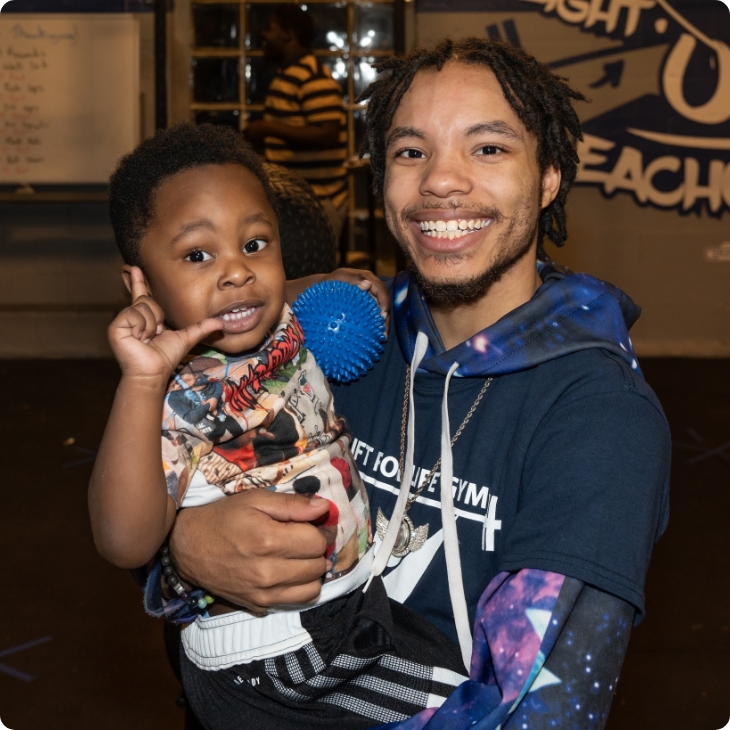 man and small child smiling at the camera